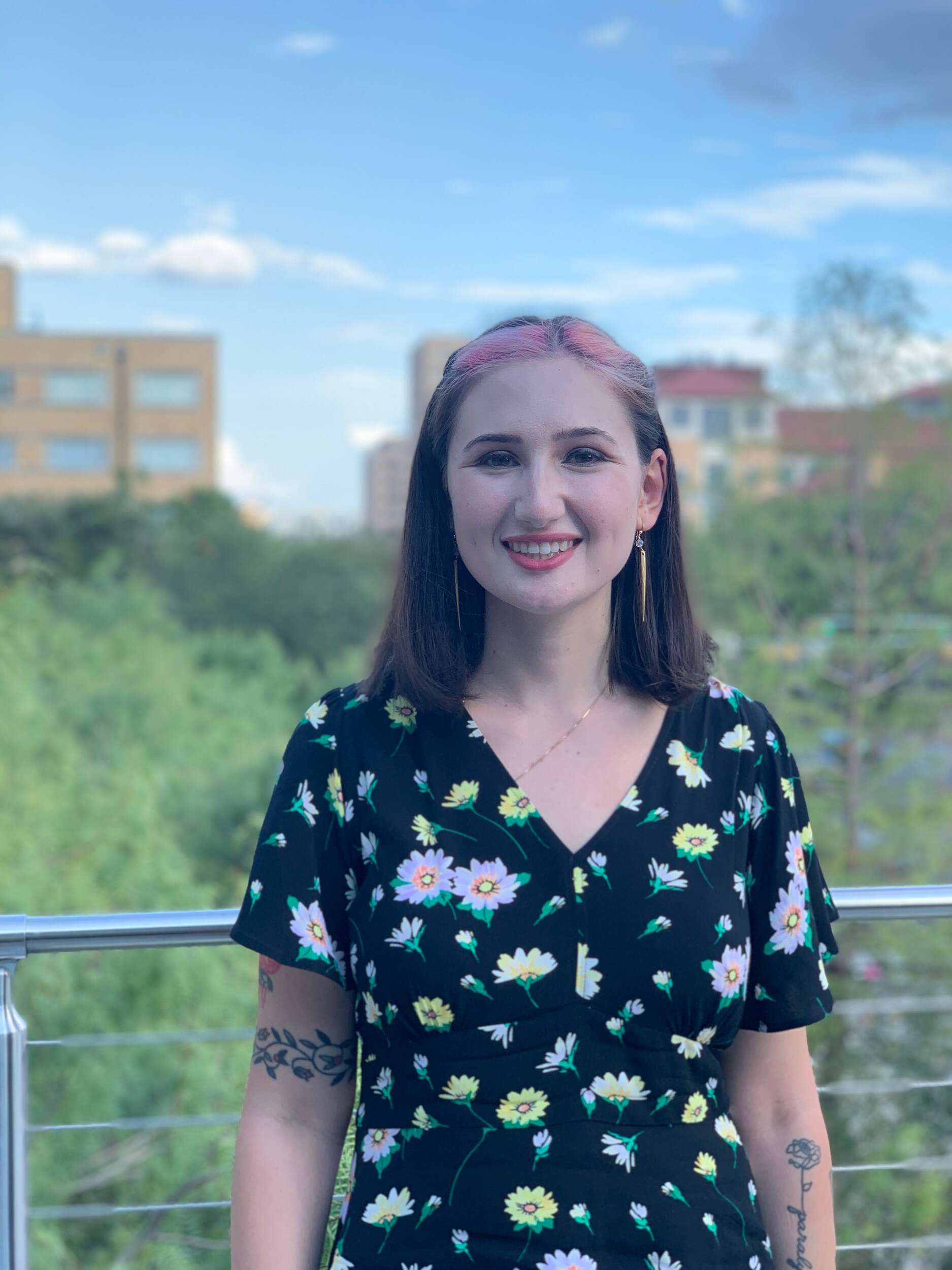 Headshot of Jess Rauchberg wearing floral print and smiling