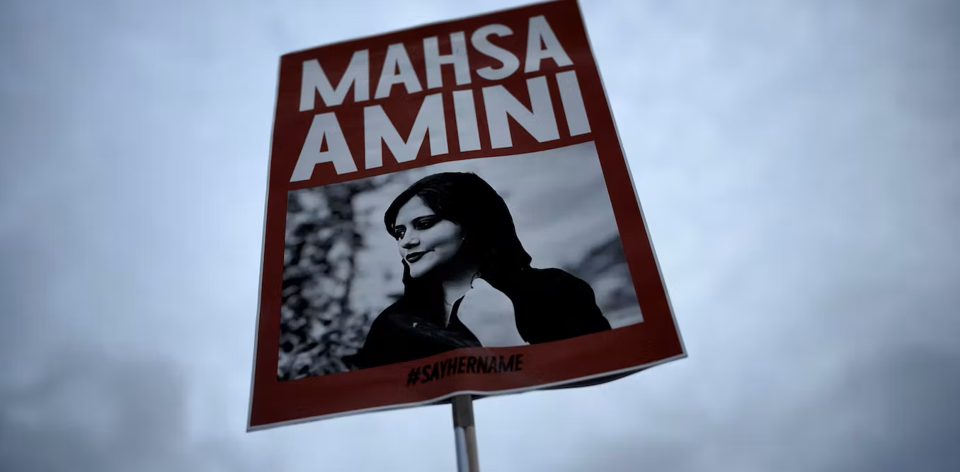 A placard with a picture of Mahsa Amini.